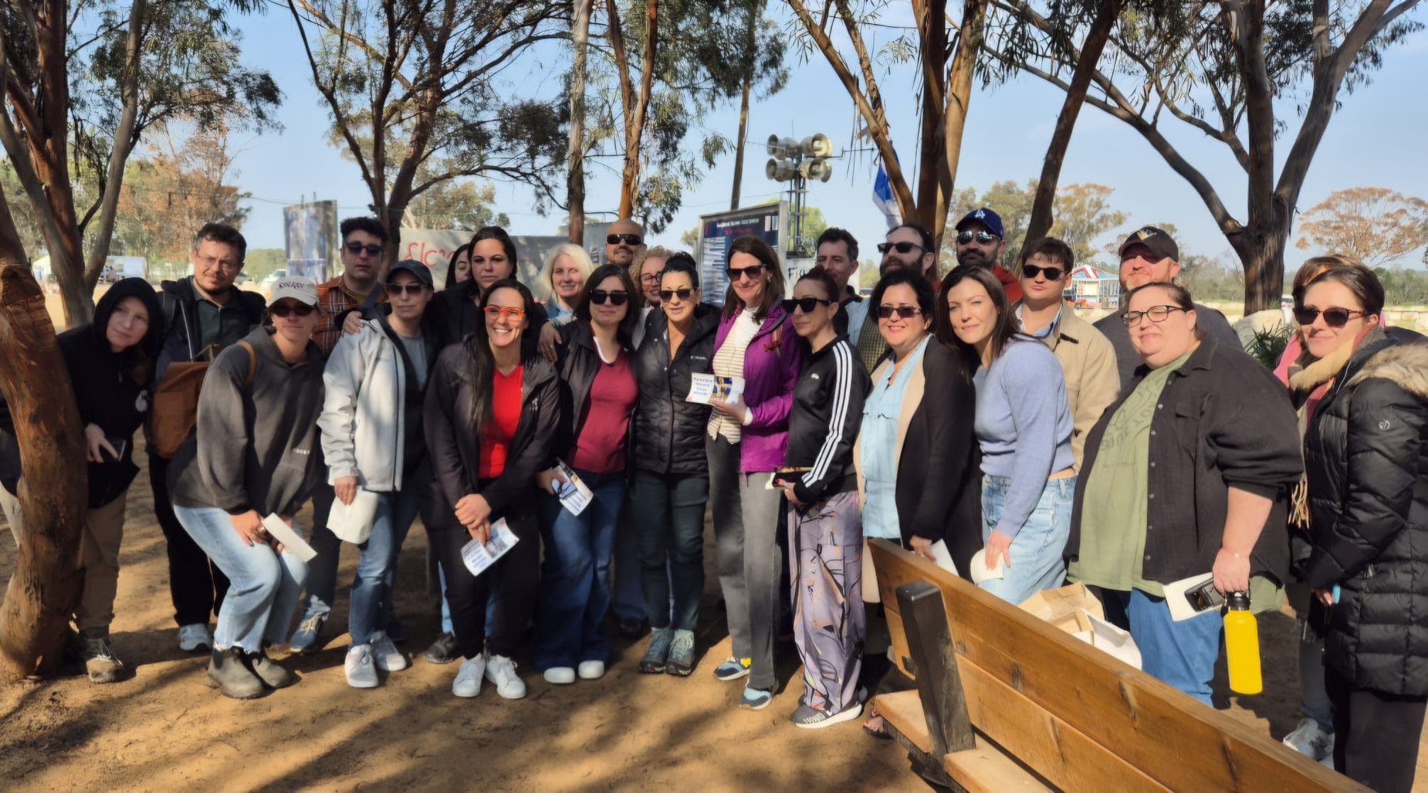 Tour group gathered among the eucalyptus trees