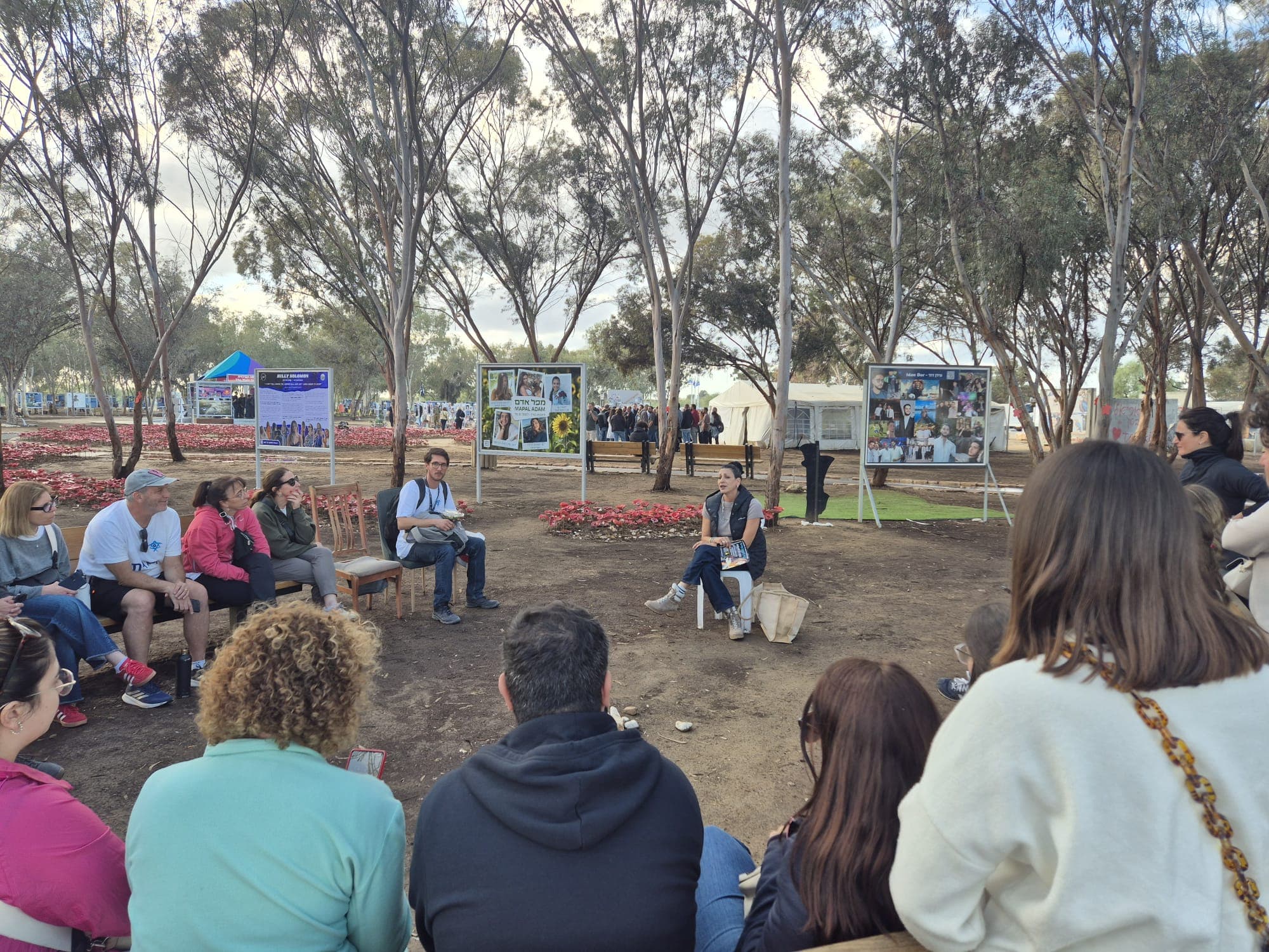Families sharing testimony in a circle at the memorial
